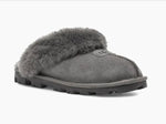 Load image into Gallery viewer, Coquette - The Classic Ugg Slipper in Grey. Nothing feels cozier than this Ugg classic slipper mule. Perfect for when you are working from home or walking the dog. Suede sheepskin upper &amp; sock lining, lightweight full rubber sole.
