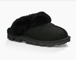 Ugg Coquette - The Classic Ugg Slipper in Black. Nothing feels cozier than this Ugg classic slipper mule. Perfect for when you are working from home or walking the dog. Suede sheepskin upper & sock lining, lighweight full rubber sole.