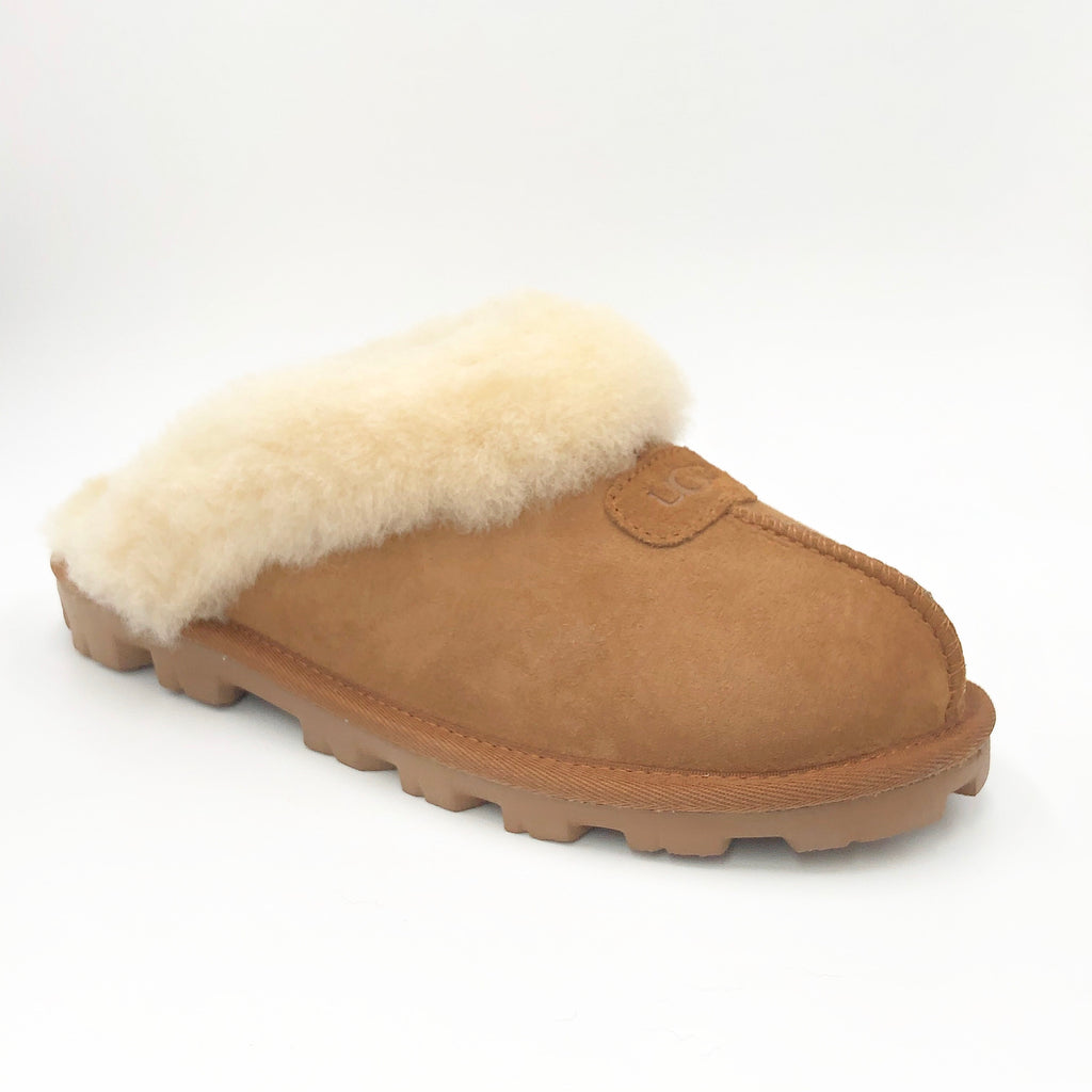 Ugg Coquette - The Classic Ugg Slipper in Chestnut. Nothing feels cozier than this Ugg classic slipper mule. Perfect for when you are working from home or walking the dog. Suede sheepskin upper & sock lining, lightweight full rubber sole.